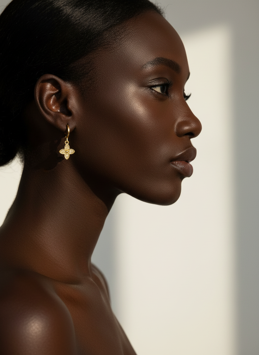 Mulher negra usando brincos de flor dourada